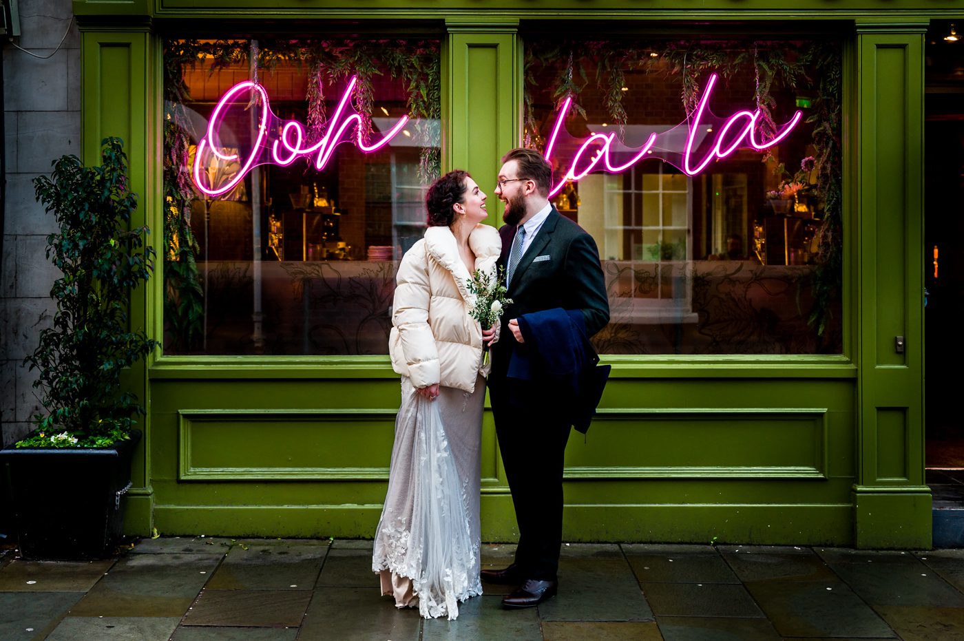 Wedding couple in front of neon sign